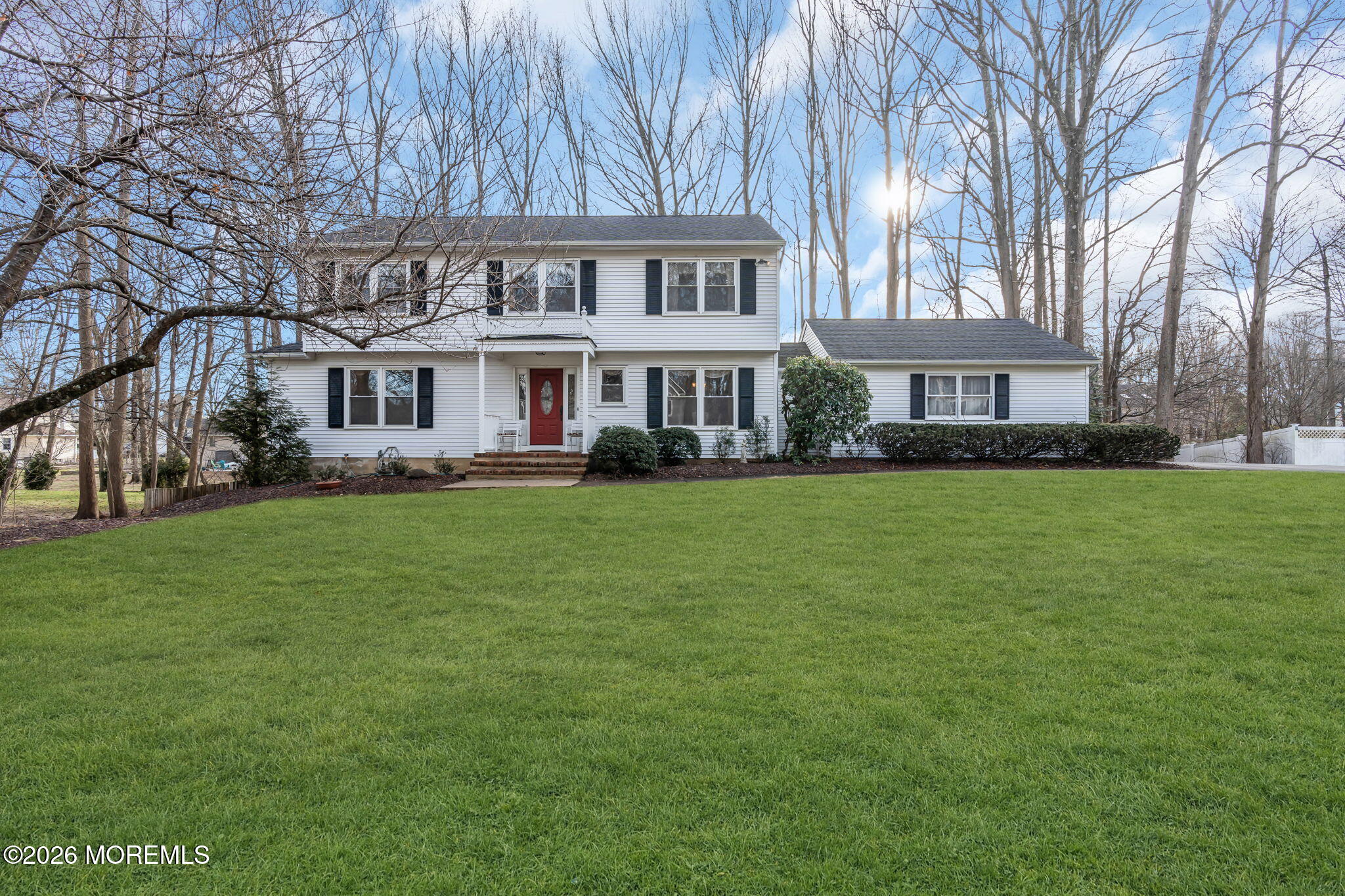 85 Radcliffe Drive Lincroft, NJ 07738 - Photo 22 of 49 a front view of a house with a garden and trees