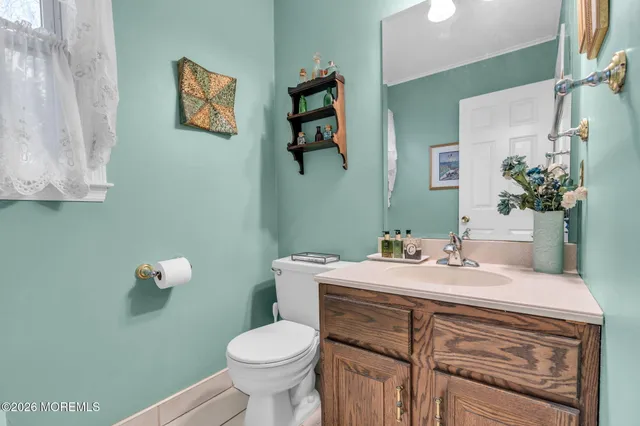 a bathroom with a sink mirror and toilet