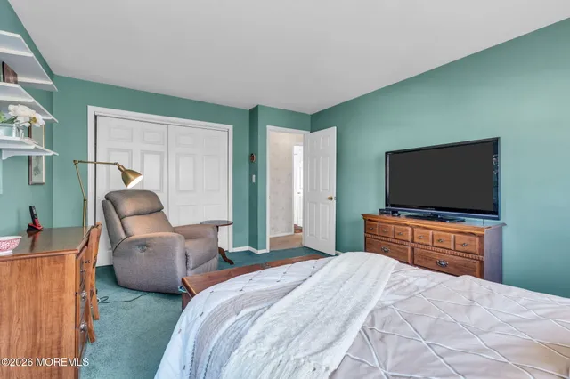 a bedroom with two beds and a television