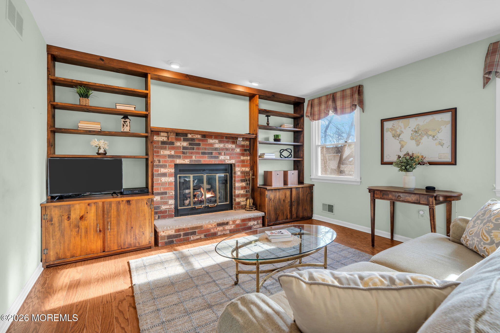 85 Radcliffe Drive Lincroft, NJ 07738 - Photo 33 of 49 a living room with furniture a flat screen tv and a fireplace