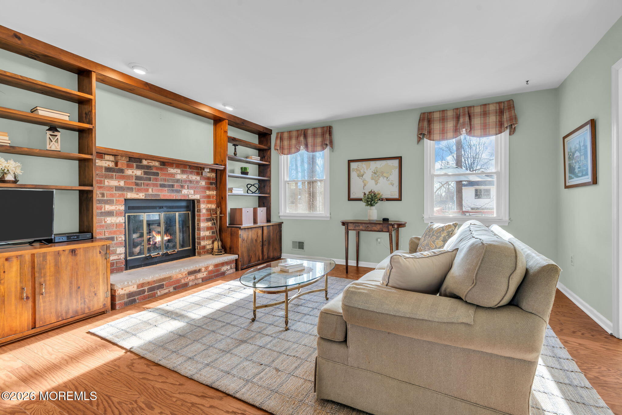 85 Radcliffe Drive Lincroft, NJ 07738 - Photo 34 of 49 a living room with furniture a flat screen tv and a fireplace