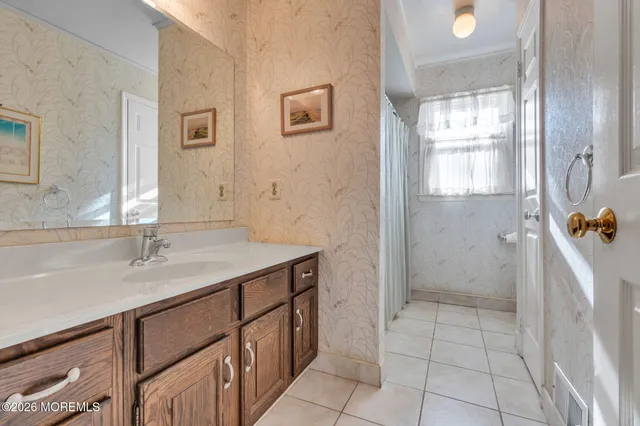 a bathroom with a sink a vanity and a mirror