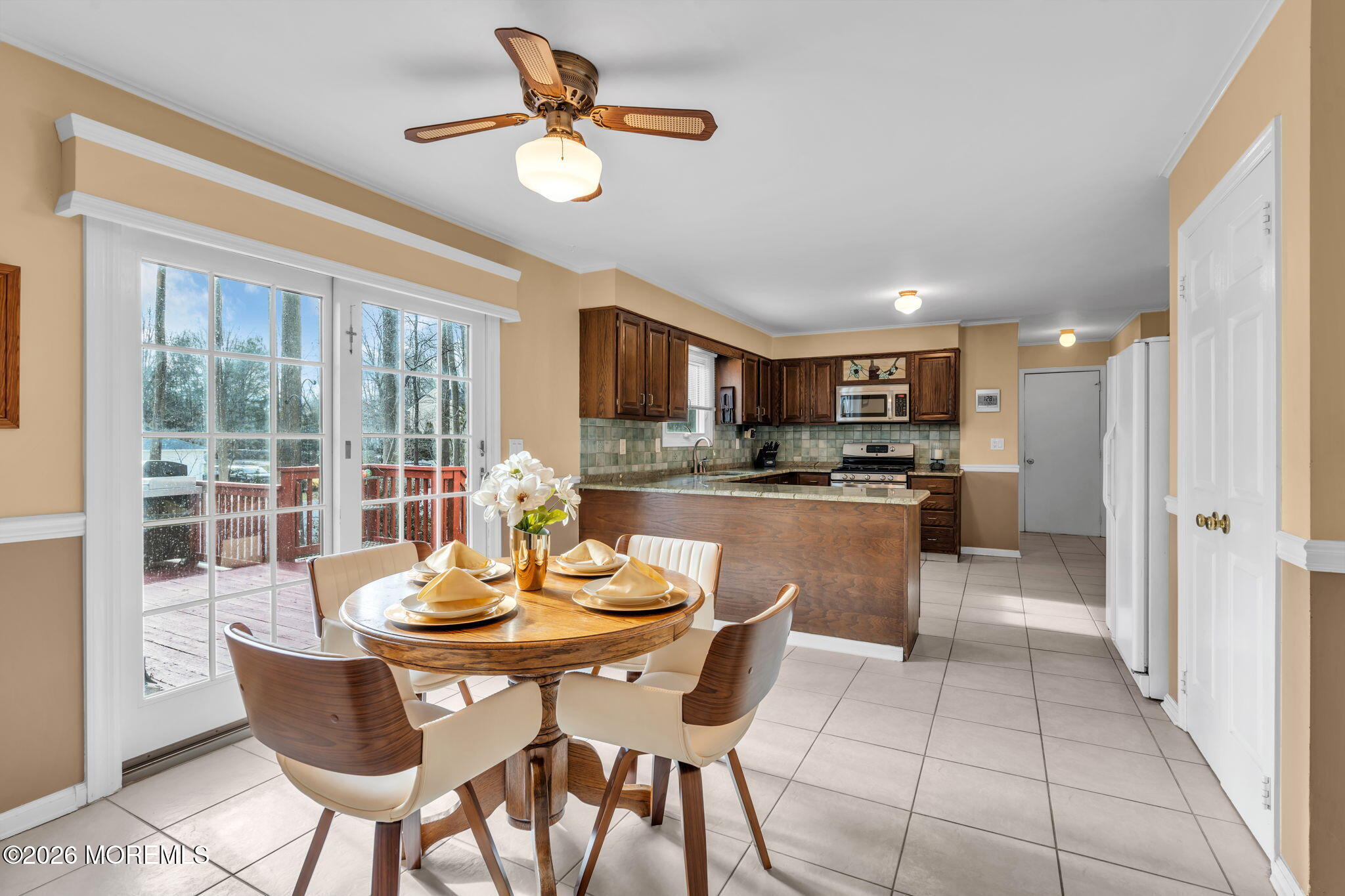 85 Radcliffe Drive Lincroft, NJ 07738 - Photo 40 of 49 a kitchen with a dining table chairs and refrigerator