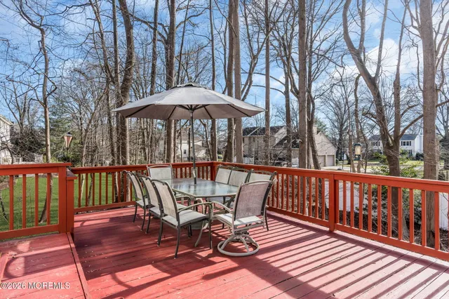 a view of a roof deck with wooden floor and fence