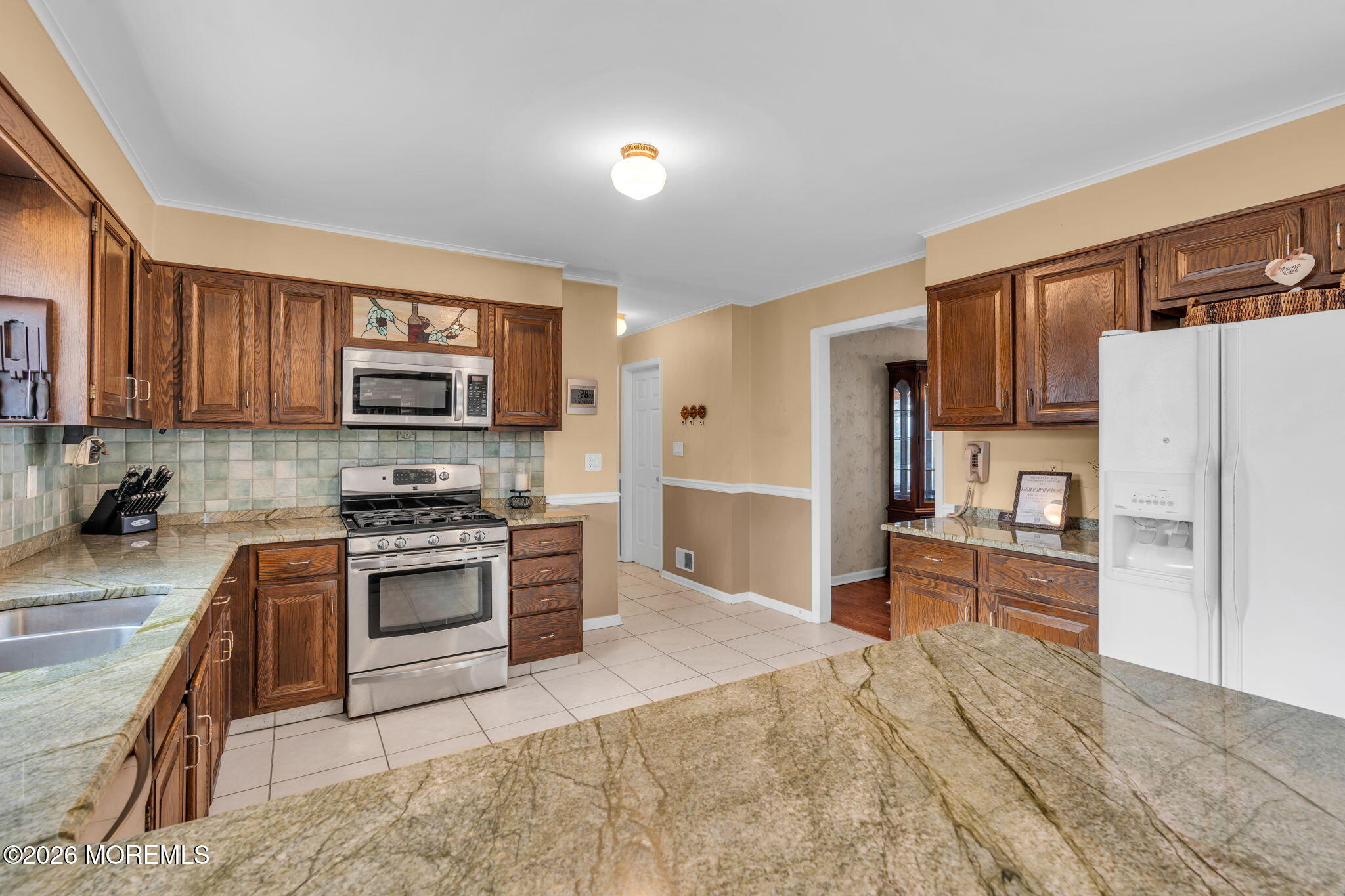 85 Radcliffe Drive Lincroft, NJ 07738 - Photo 45 of 49 a kitchen with stainless steel appliances granite countertop a refrigerator stove microwave and sink