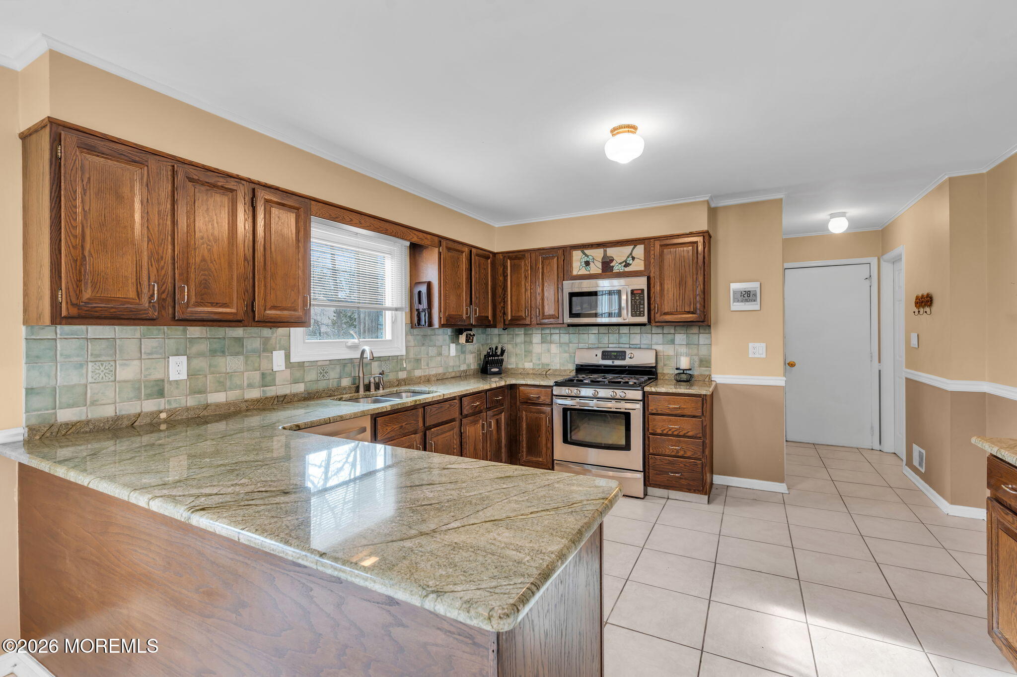 85 Radcliffe Drive Lincroft, NJ 07738 - Photo 46 of 49 a kitchen with stainless steel appliances granite countertop a sink stove and refrigerator