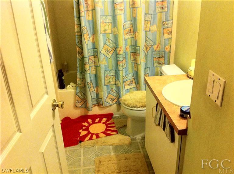 8193 Pelican Road Fort Myers, FL 33967 - Photo 2 of 5 a bathroom with a sink toilet and shower