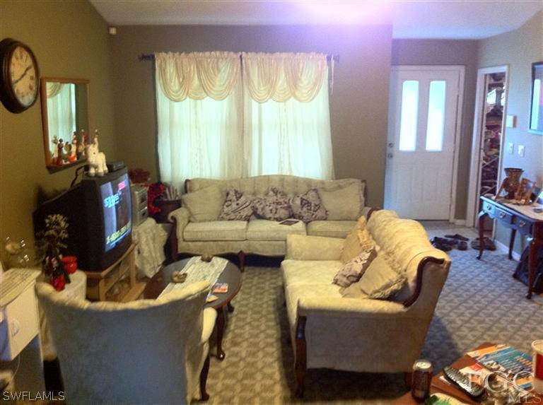 8193 Pelican Road Fort Myers, FL 33967 - Photo 3 of 5 a living room with furniture and a large window