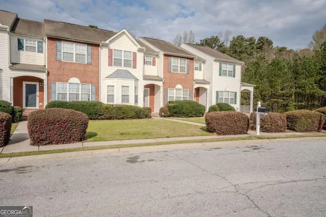 a front view of a house with a garden