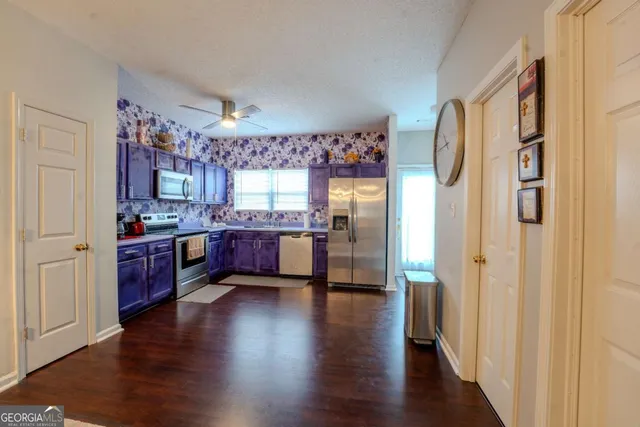 a view of kitchen with cabinets and wooden floor