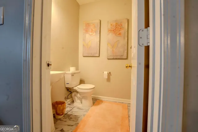 a bathroom with a toilet and shower