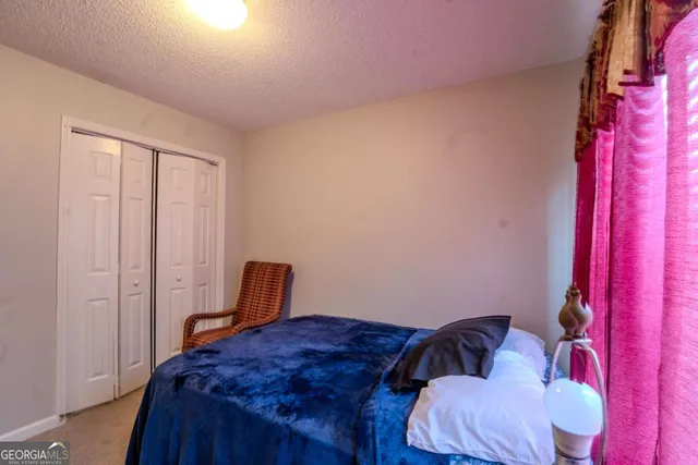 a bedroom with a bed and chair