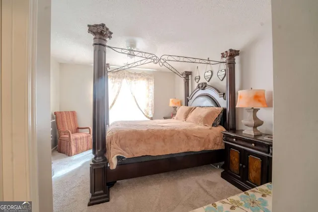 a bedroom with a bed and a mirror