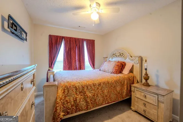 a bed sitting in a bedroom next to a window