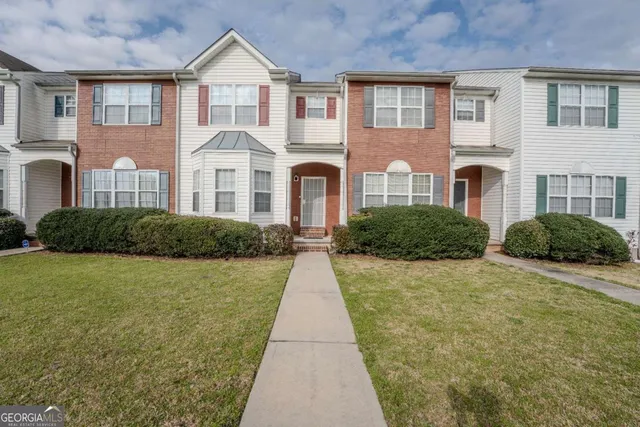a front view of a house with yard