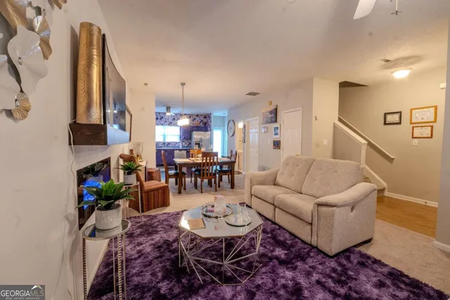 a living room with furniture and a dining table