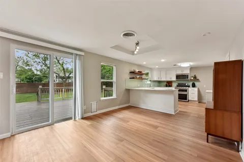 a view of kitchen with wooden floor and electronic appliances