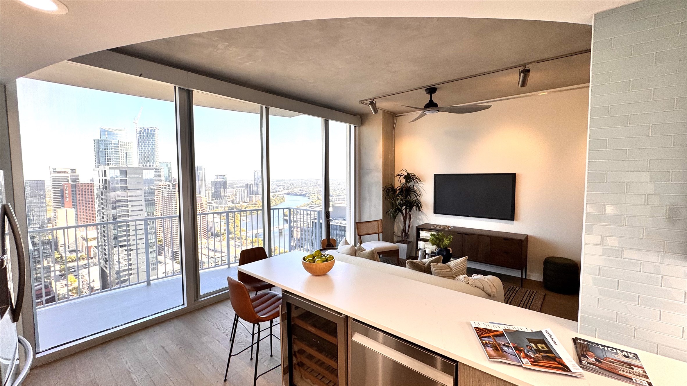 360 Nueces Street, Unit 4203 Austin, TX 78701 - Photo 3 of 40 Dining space featuring light wood flooring, a wall of windows, wine cooler, track lighting, and ceiling fan
