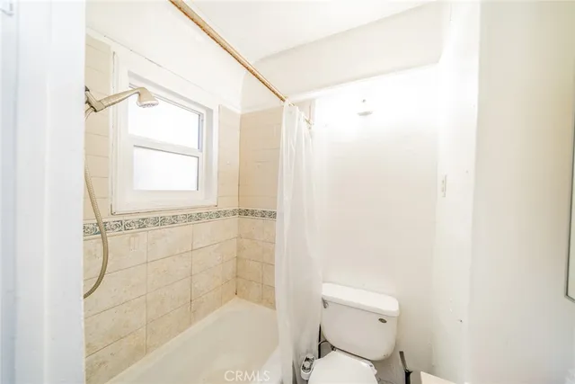 a bathroom with a shower and a toilet