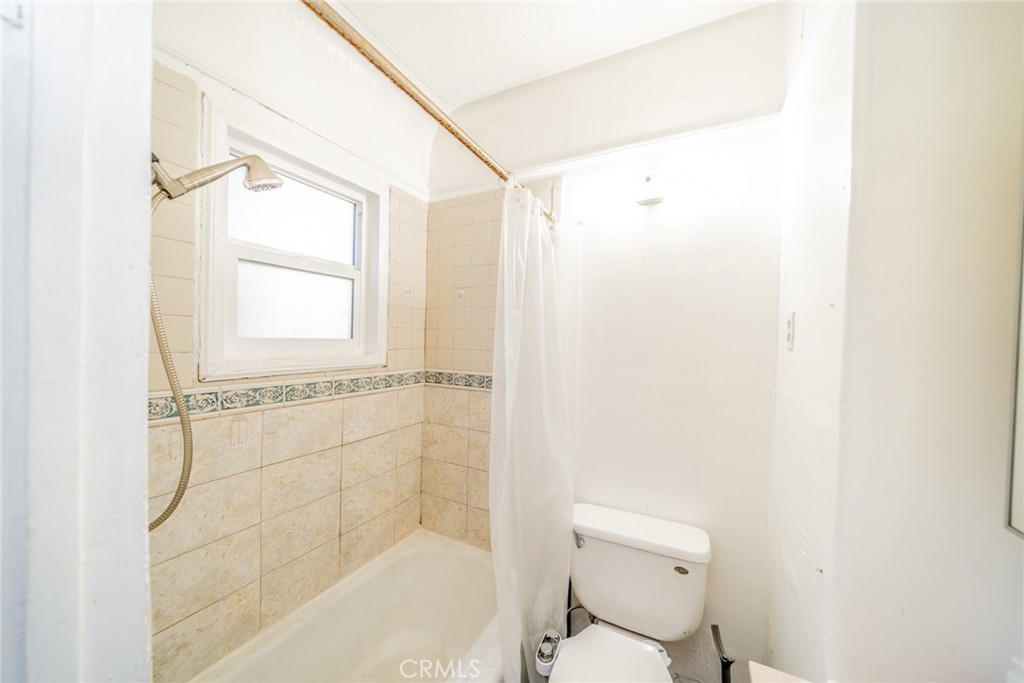 3987 4th Street Riverside, CA 92501 - Photo 12 of 33 a bathroom with a shower and a toilet