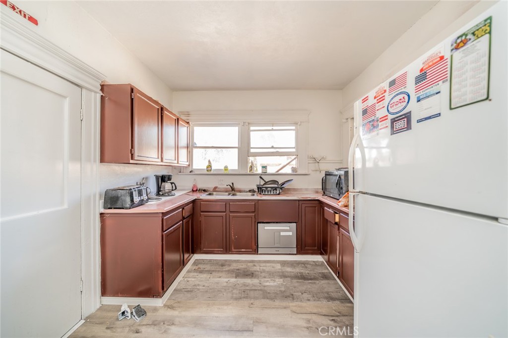 3987 4th Street Riverside, CA 92501 - Photo 16 of 33 a kitchen with granite countertop a refrigerator and a sink