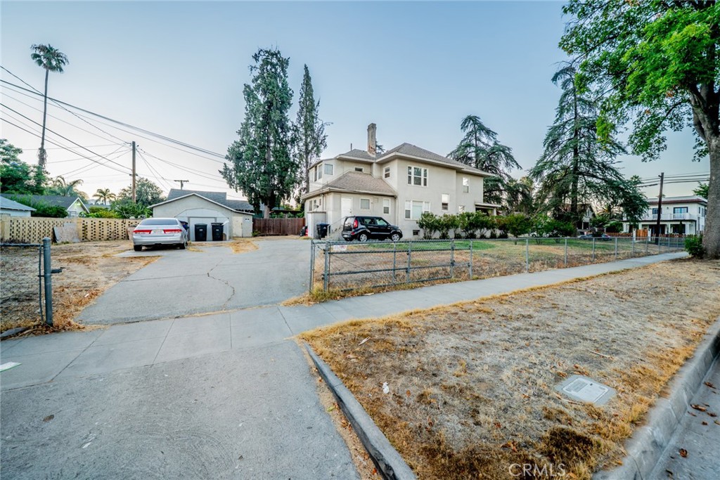 3987 4th Street Riverside, CA 92501 - Photo 27 of 33 a view of a white house next to a road and yard