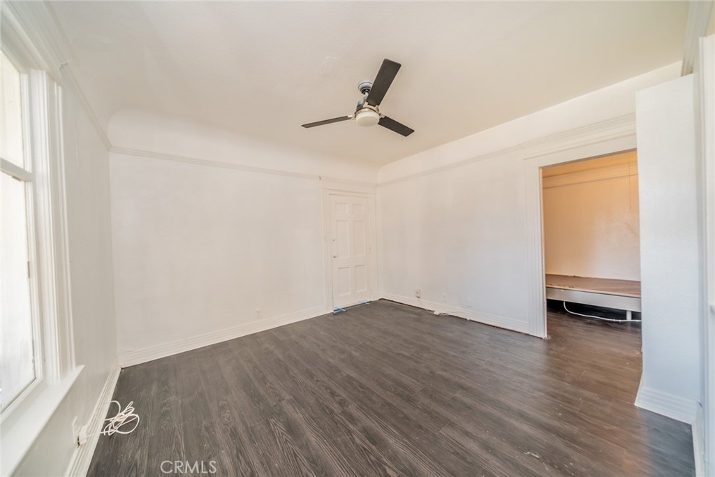 3987 4th Street Riverside, CA 92501 - Photo 9 of 33 an empty room with wooden floor and windows