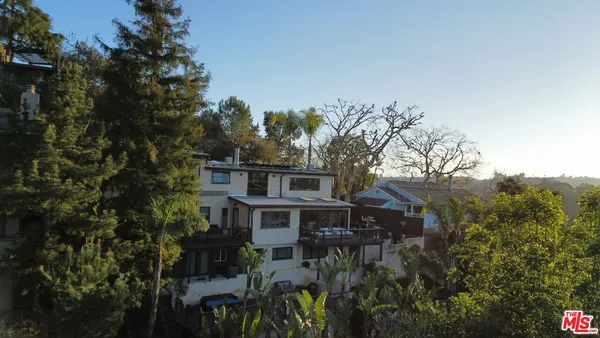 a view of a house with a tree in the background