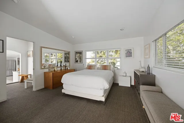 a spacious bedroom with a bed and a couch