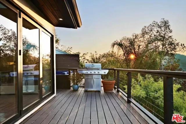 a view of a balcony with furniture and wooden floor