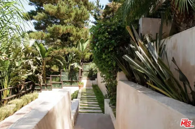 a view of a balcony with chairs and wooden floor