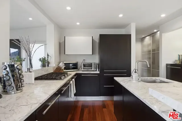 a kitchen with a sink stove and refrigerator