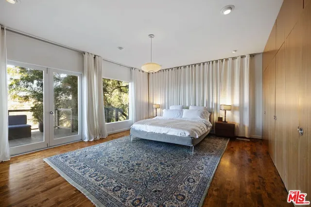 a spacious bedroom with a large bed and a window