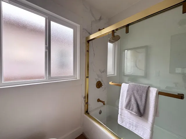 a view of a house with backyard and wooden fence