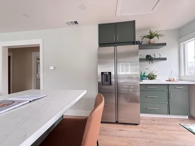 a bathroom with a granite countertop sink mirror and toilet