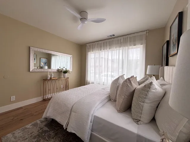 a bedroom with a large bed and a window