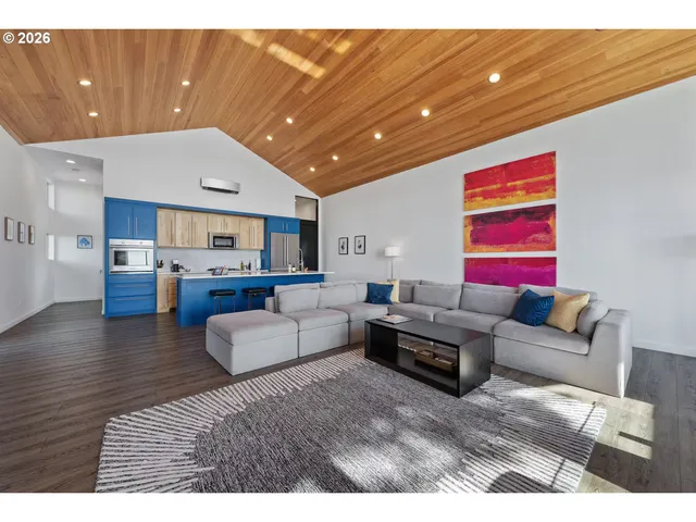 a living room with furniture and kitchen view