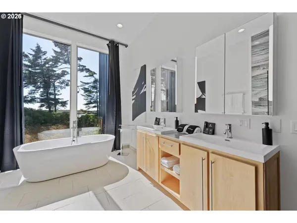 a spacious bathroom with a bathtub and a sink