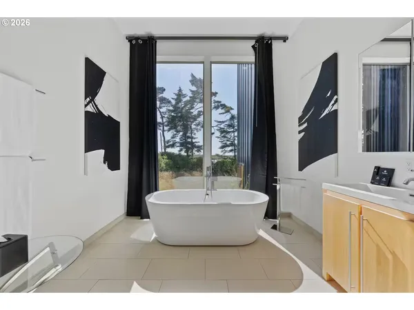 a large bathroom with a tub a sink a mirror and a shower