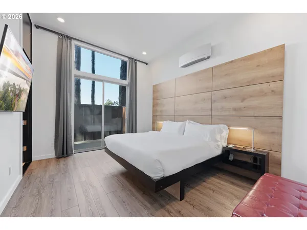 a bedroom with a bed and a flat screen tv