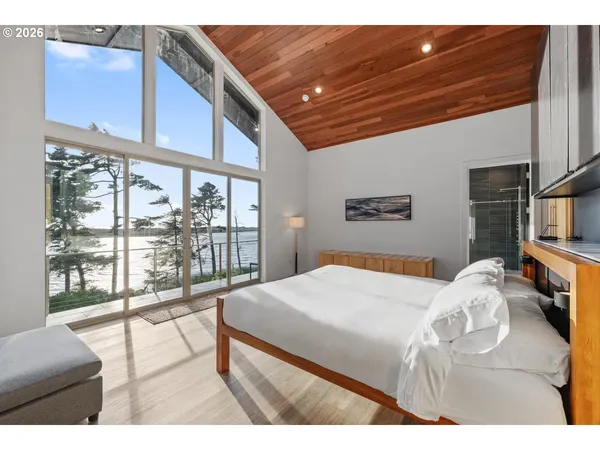 a bedroom with a bed and a large window