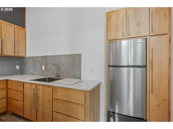 a kitchen with a sink a microwave a stove and cabinets