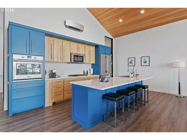 a kitchen with granite countertop a sink cabinets and wooden floor