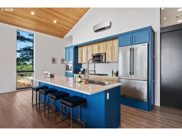 a kitchen with stainless steel appliances granite countertop a sink refrigerator and cabinets