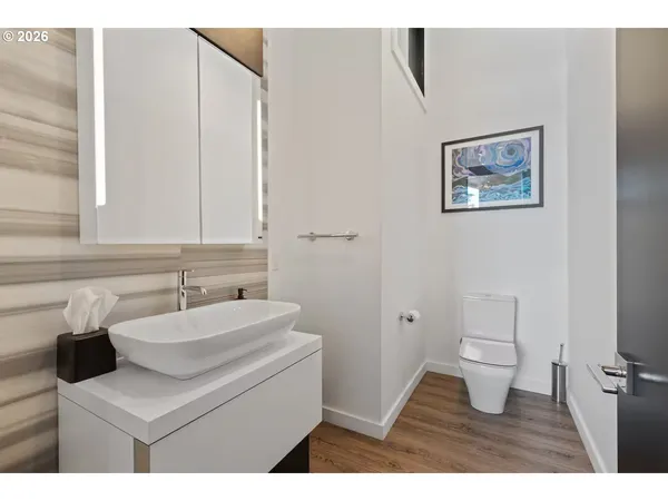 a bathroom with a sink toilet and a mirror