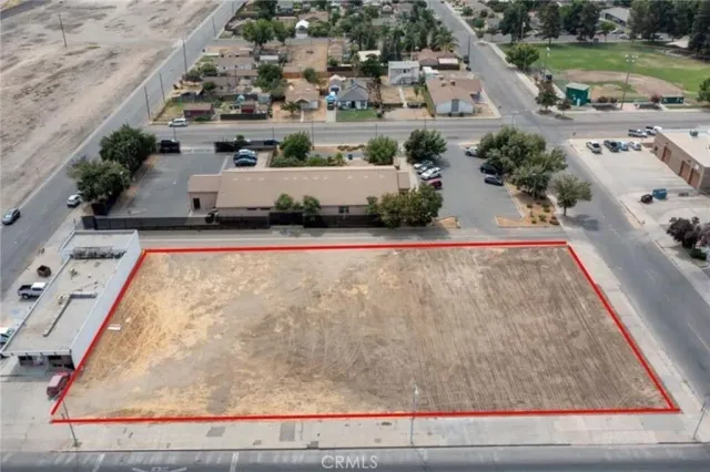 an aerial view of a house with a yard and lake view