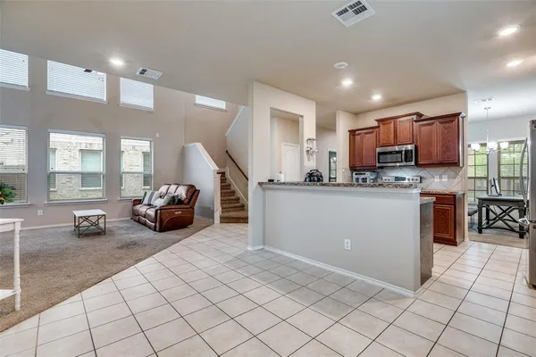 a kitchen with stainless steel appliances a stove a sink and a refrigerator