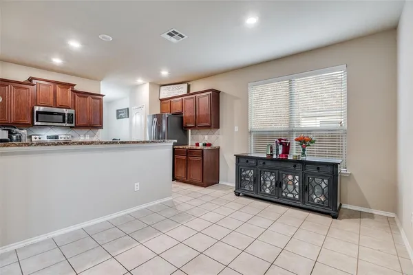 a kitchen with granite countertop a sink and a stove