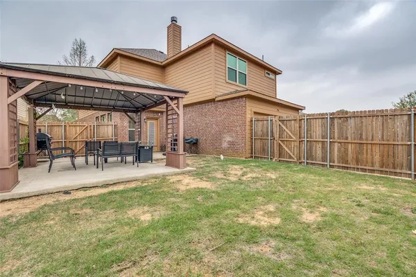 a view of a backyard with sitting area