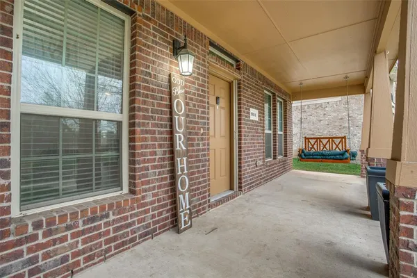 a view of a porch with wooden floor and fence